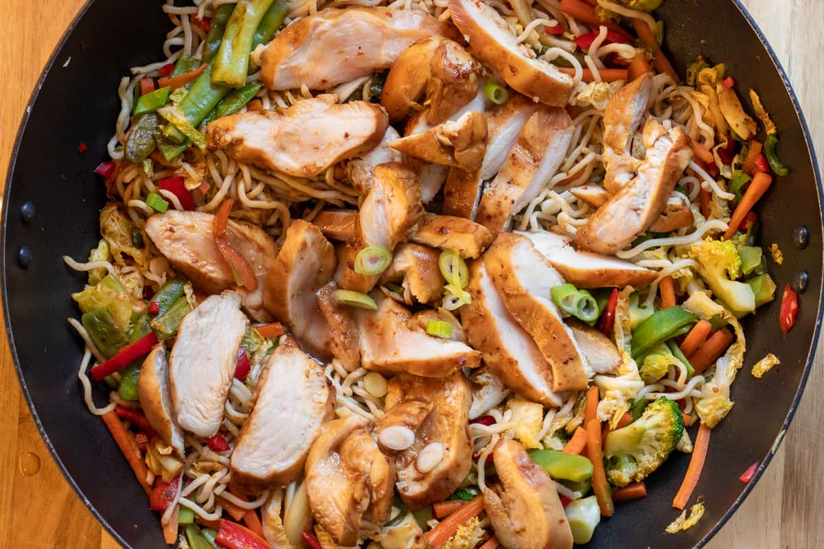 chicken slices are added to the stir fried vegetables