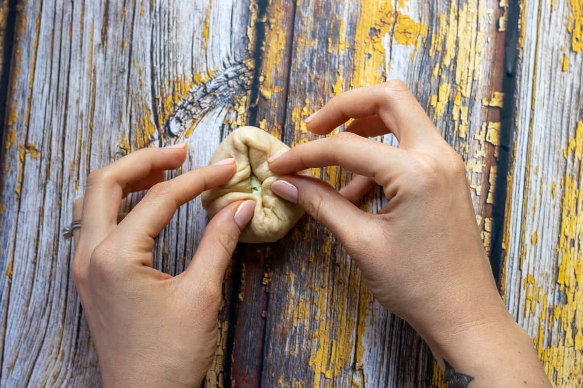 the dough is folded over the mixture to meet in the centre