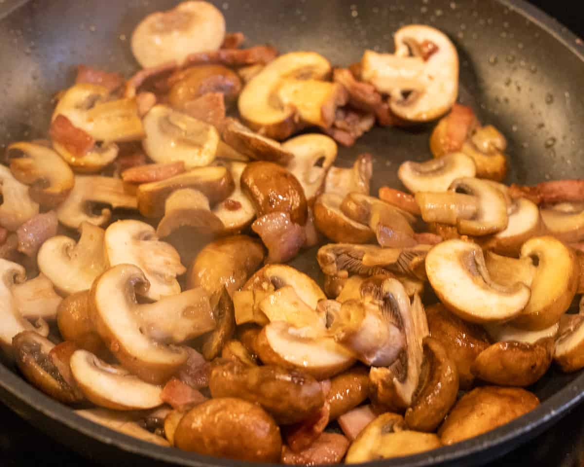 Sautéing the mushrooms with bacon