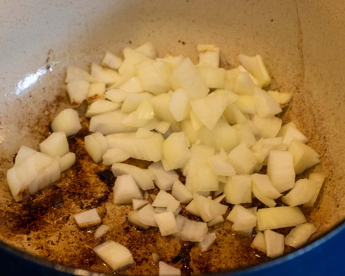 sautéing the onions with marinated beef pieces