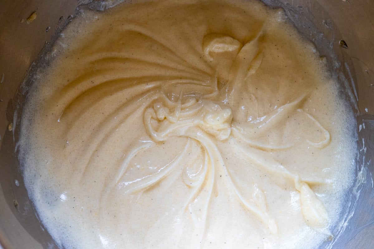 butter, sugar and eggs are mixed in a bowl