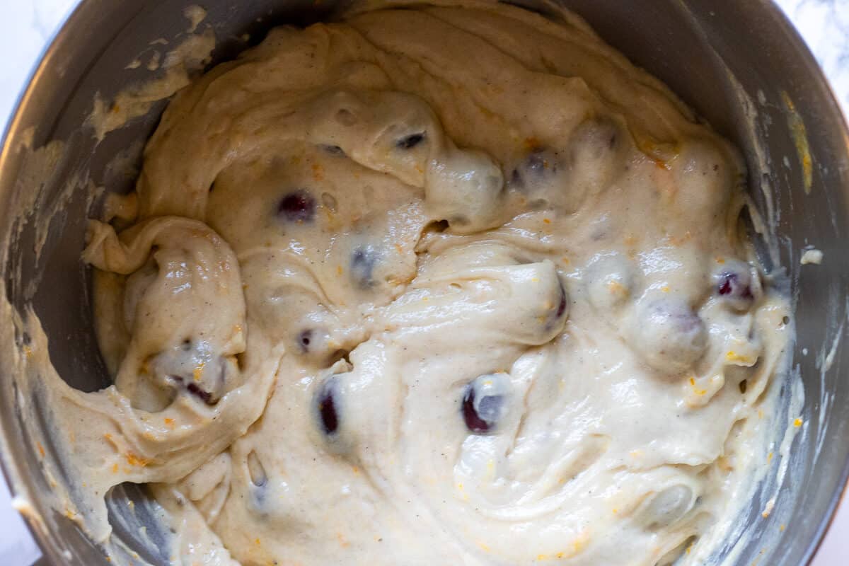 cranberries and orange zest are mixed with muffin batter