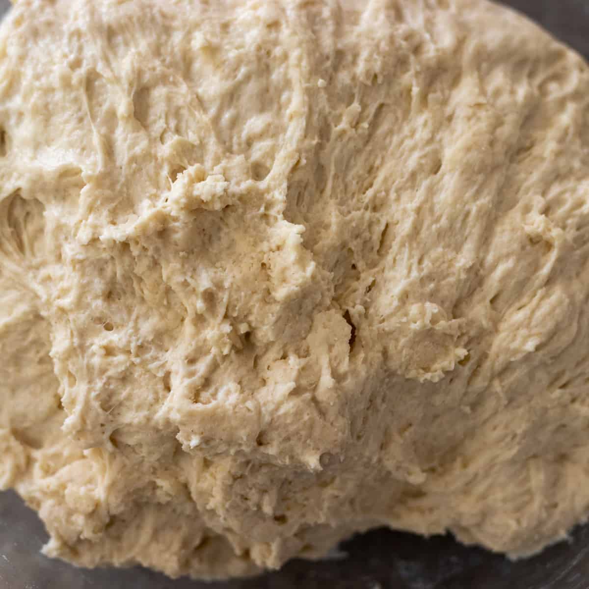 bazlama dough is in a bowl before rising