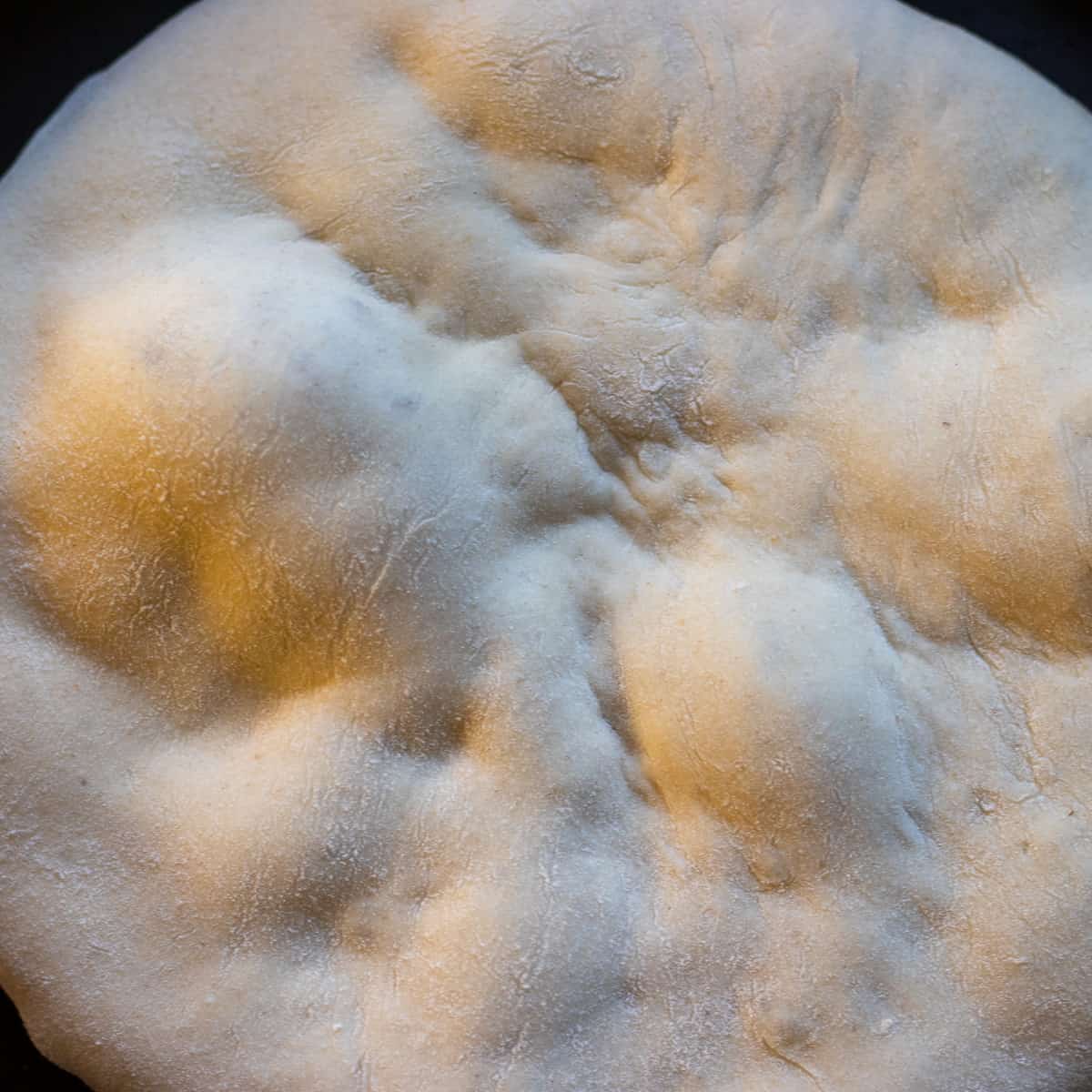 cooking bazlama on a pan