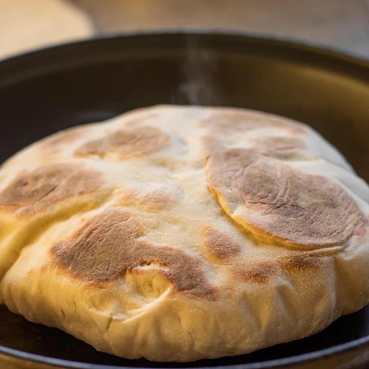 bazlama is flipped to cook the other side