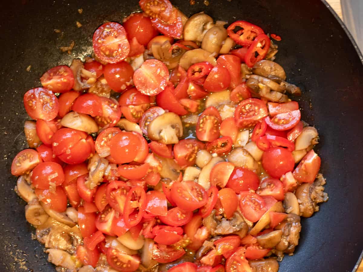 tomatoes are added to the mushrooms