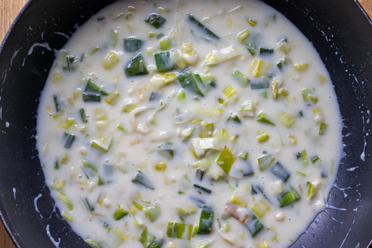the milk is added to the flour and leek mixture