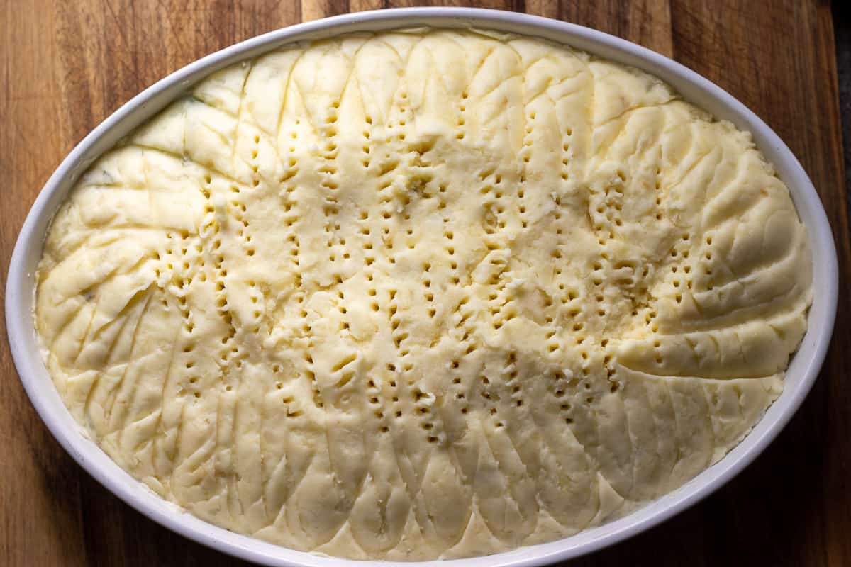 the fish pie mixture is covered with mashed potatoes