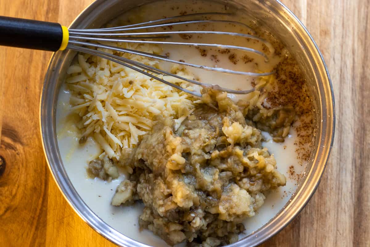 adding the aubergines and cheese to béchamel