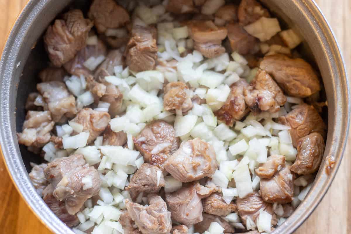 Sautéing the onions with lamb
