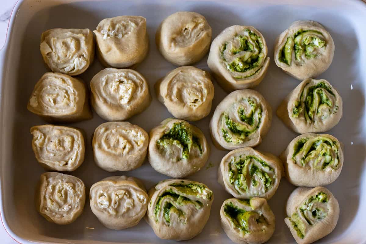 the dough log is cut into 10 equal pieces and placed on a tray