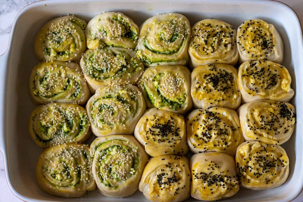 sesame seeds and nigella seeds are sprinkled on pitka bread buns