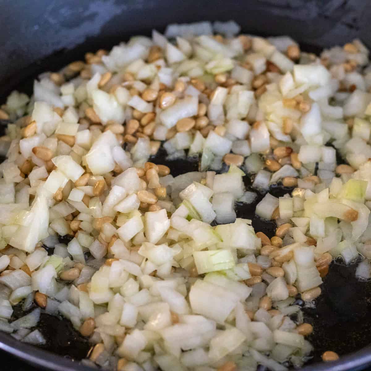 saute onions and pine nuts in olive oil