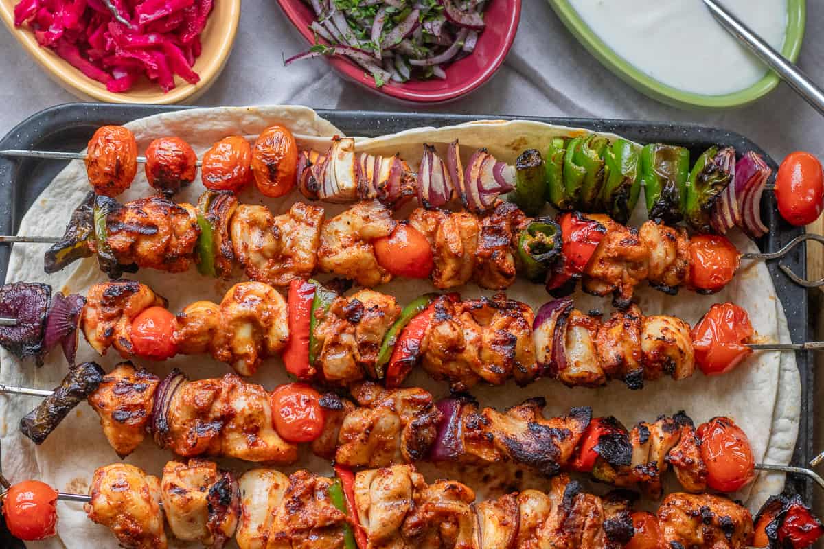 chicken Shish Kebabs served with yogurt, onion salad, and red cabbage on the side