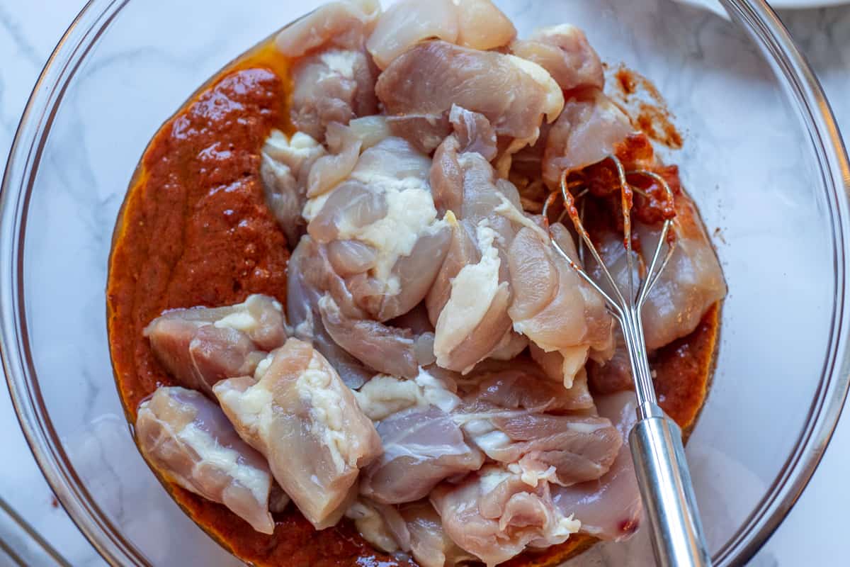 add the chicken pieces into the bowl with the Marinade