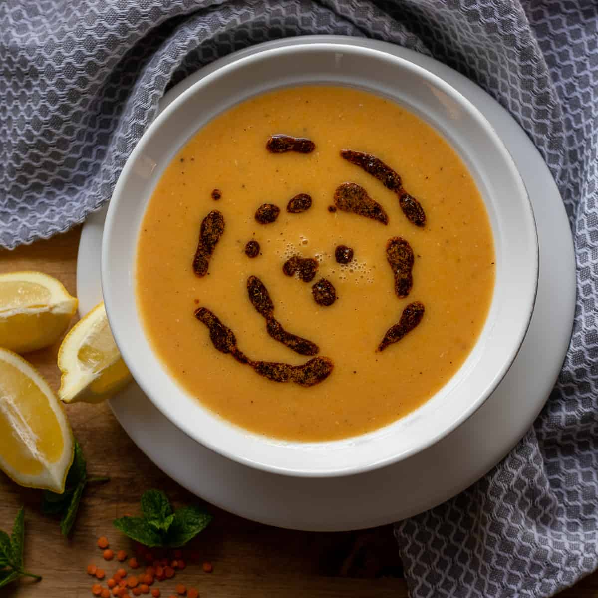 Turkish red lentil soup is served with a slice of lemon