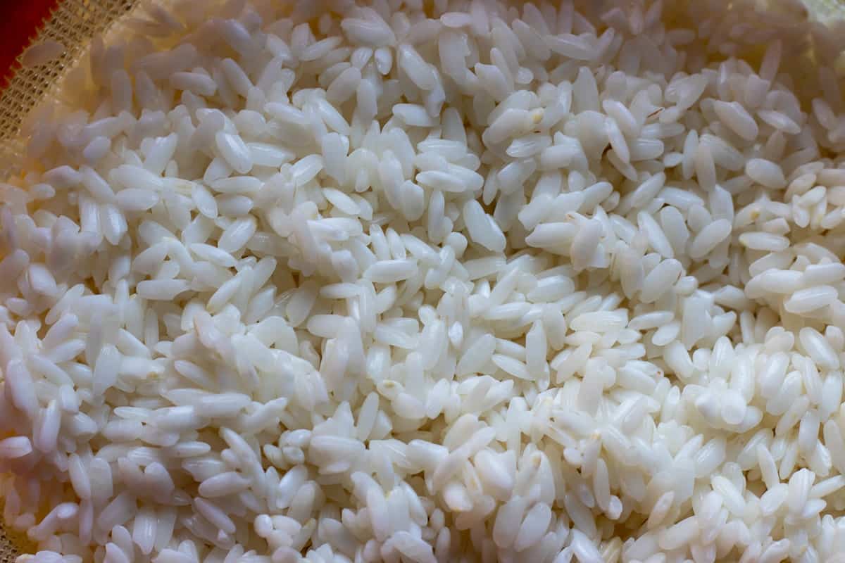 Soaked and drained rice in a colander.