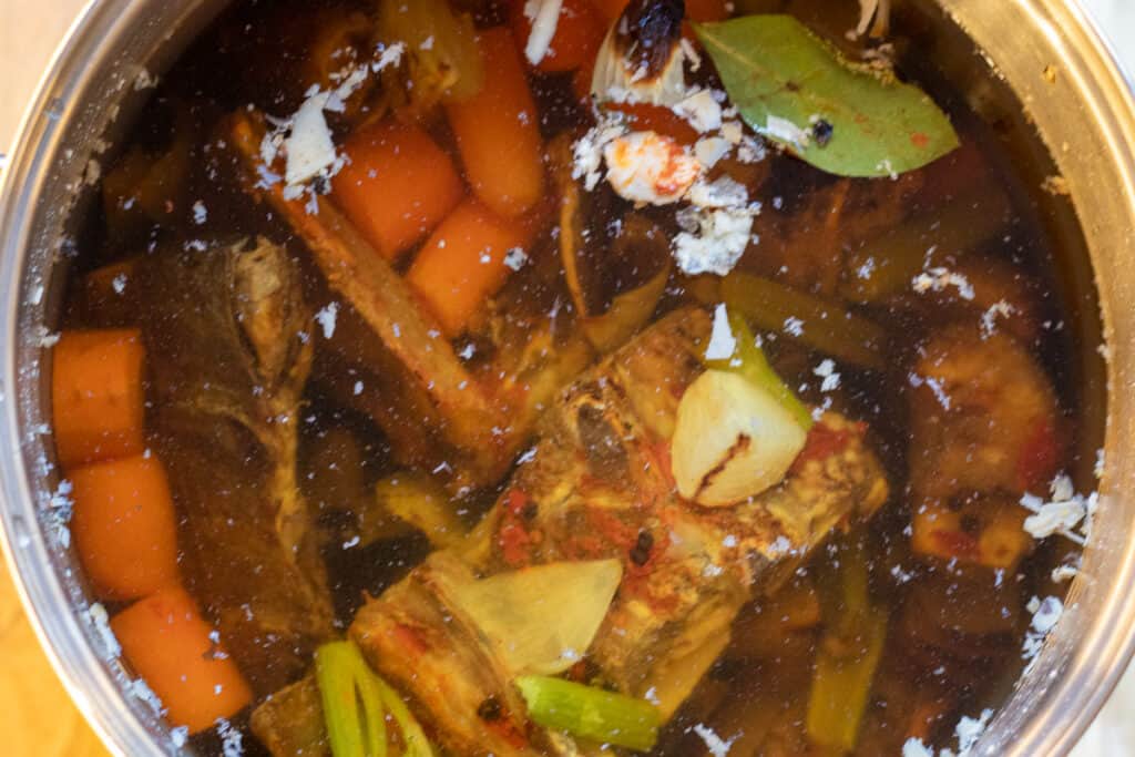 add the bones and vegetables in a pot and fill with cold water