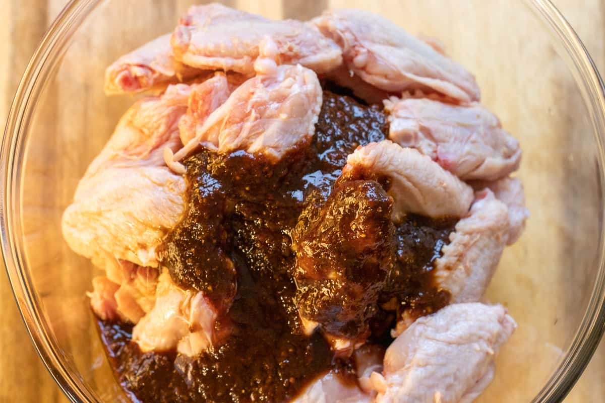 the marinade is poured on the chicken wings
