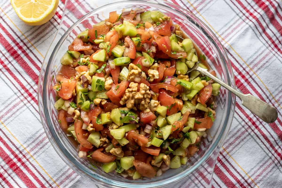 Gavurdagi Salatasi Turkish tomato walnut salad served with some lemon