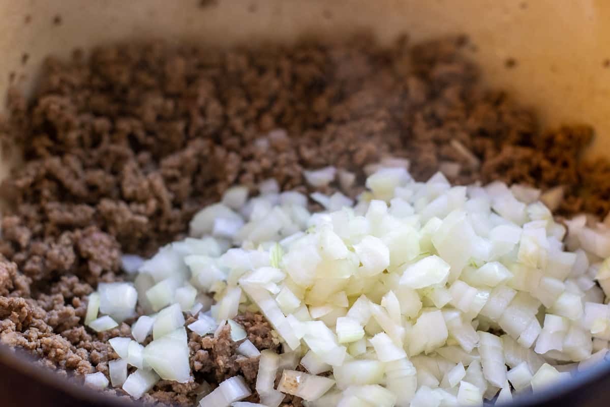 Sautéing the onions with the browned mince