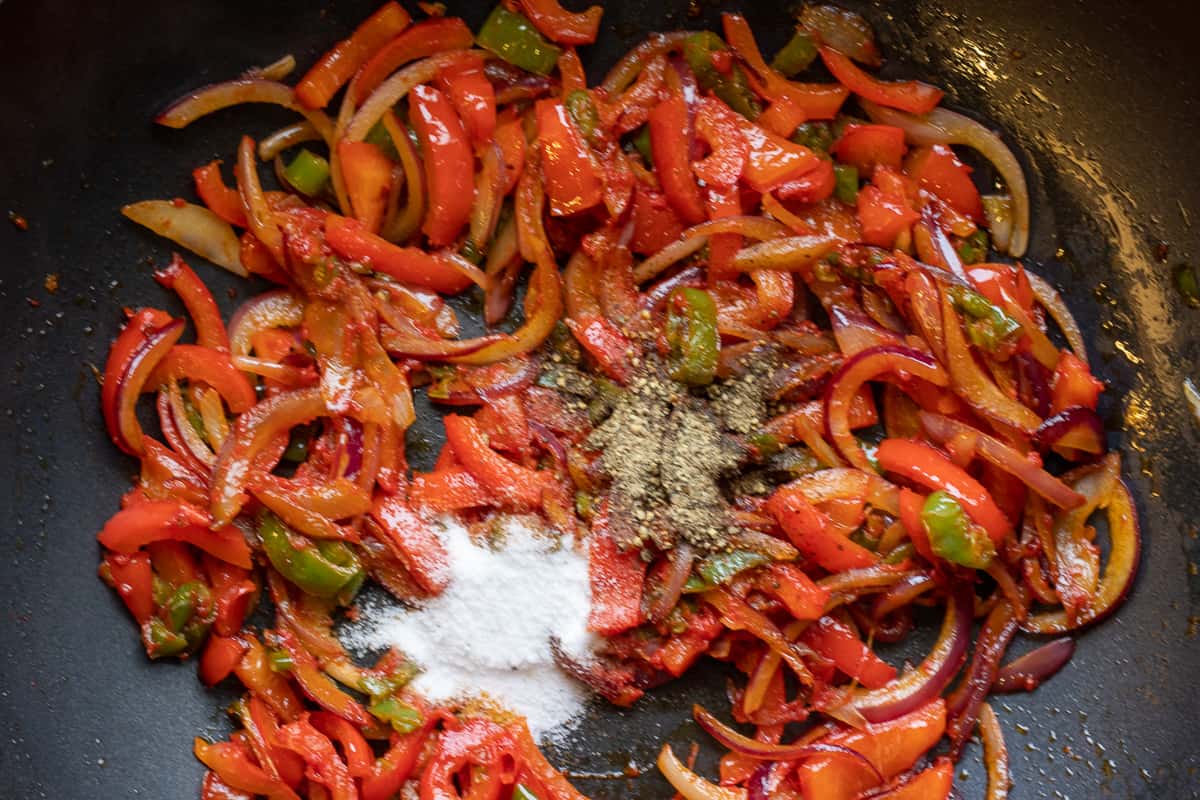 Tomato paste and the seasoning are added to the sautéed vegetables