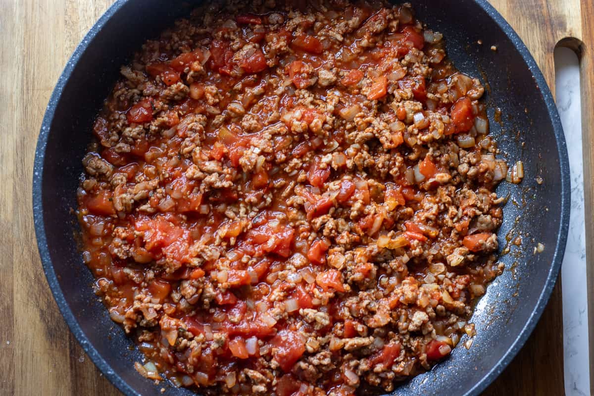tomatoes are added to the pan