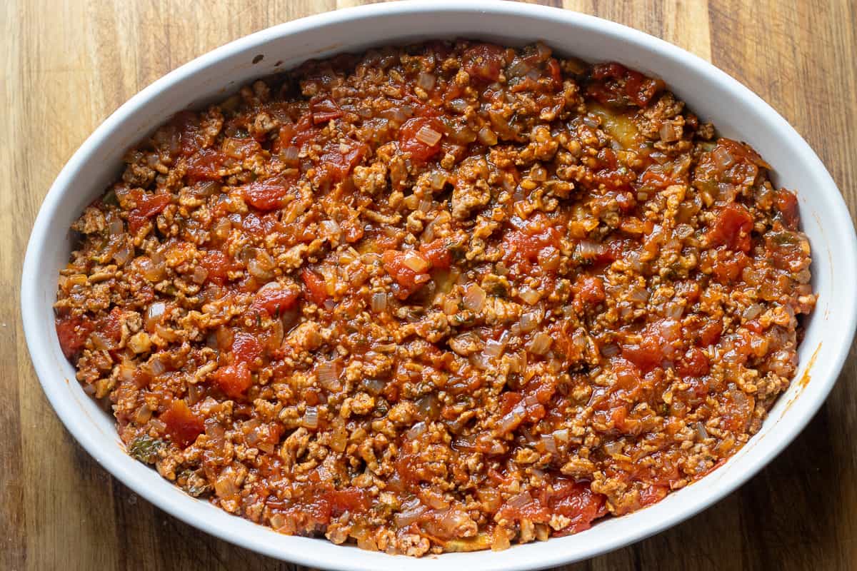 remaining meat sauce is layered on top of the potatoes