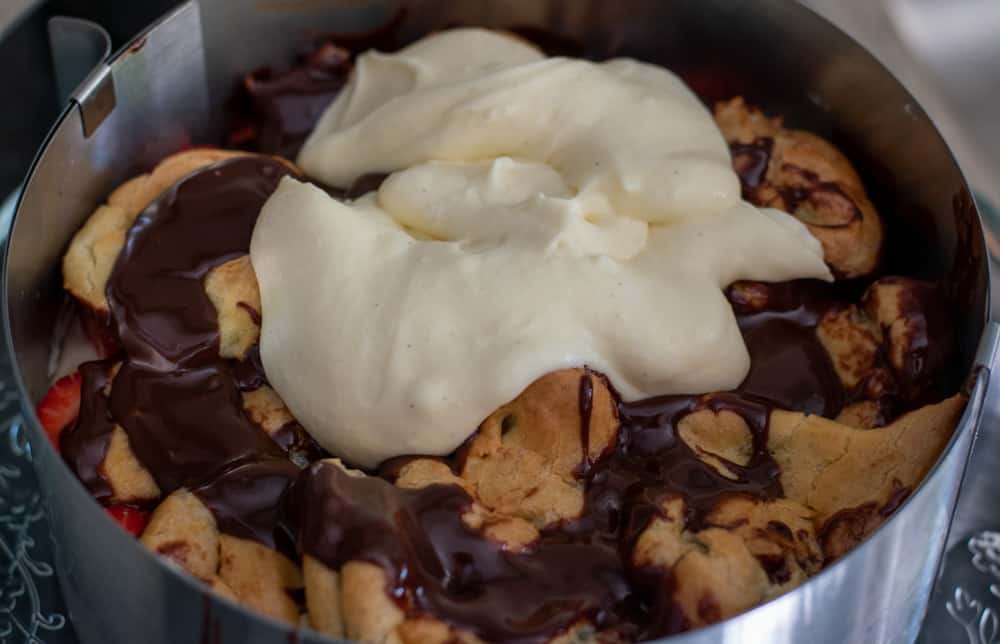 ½ of the diplomat cream is piped on choux pastries