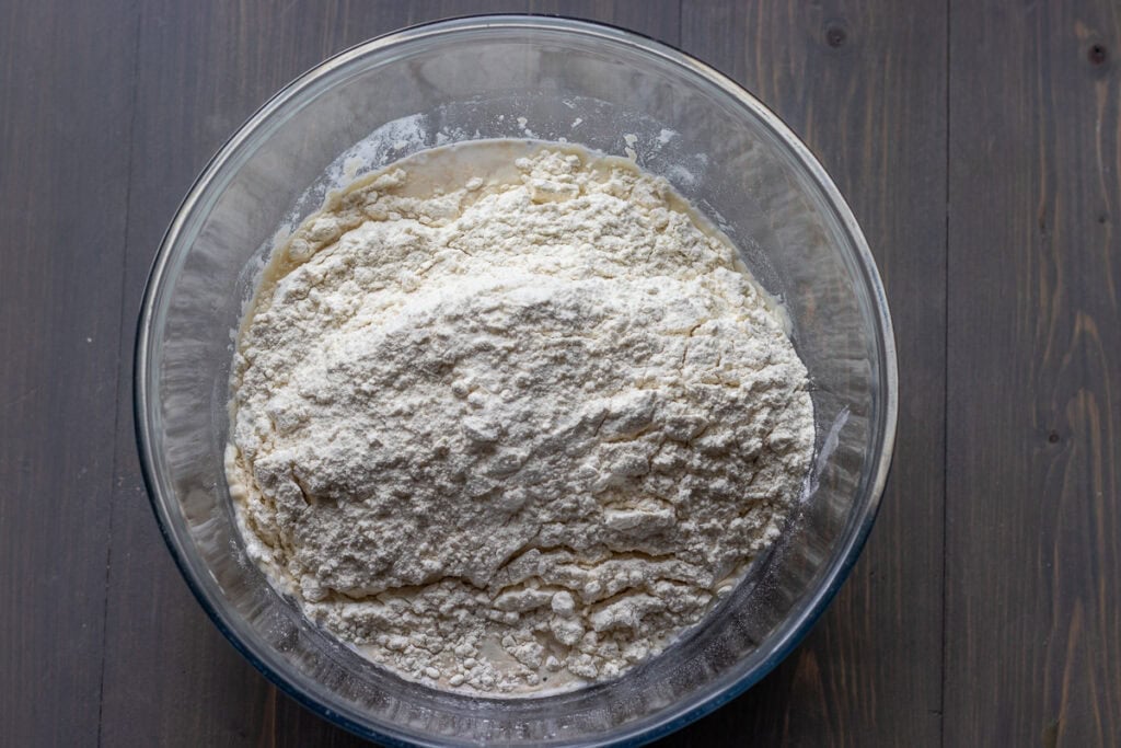 Flour and salt are added to yeast mixture.