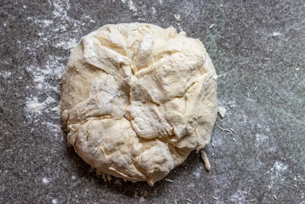 A soft and sticky dough is formed with yeast mixture and flour.
