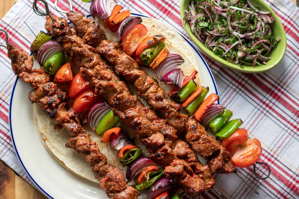 lamb Shish Kebabs are served with onion salad