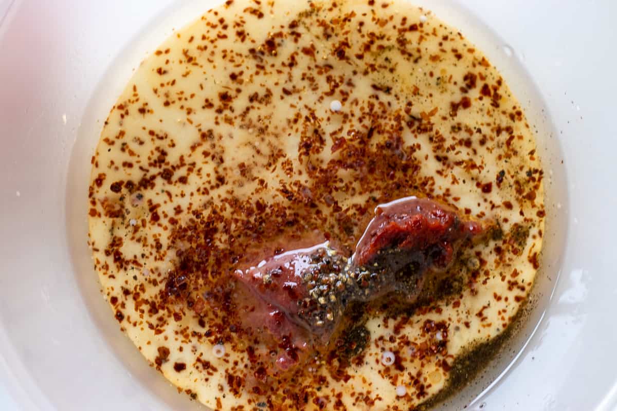 onion juice, tomato paste, spices and milk are placed in a bowl