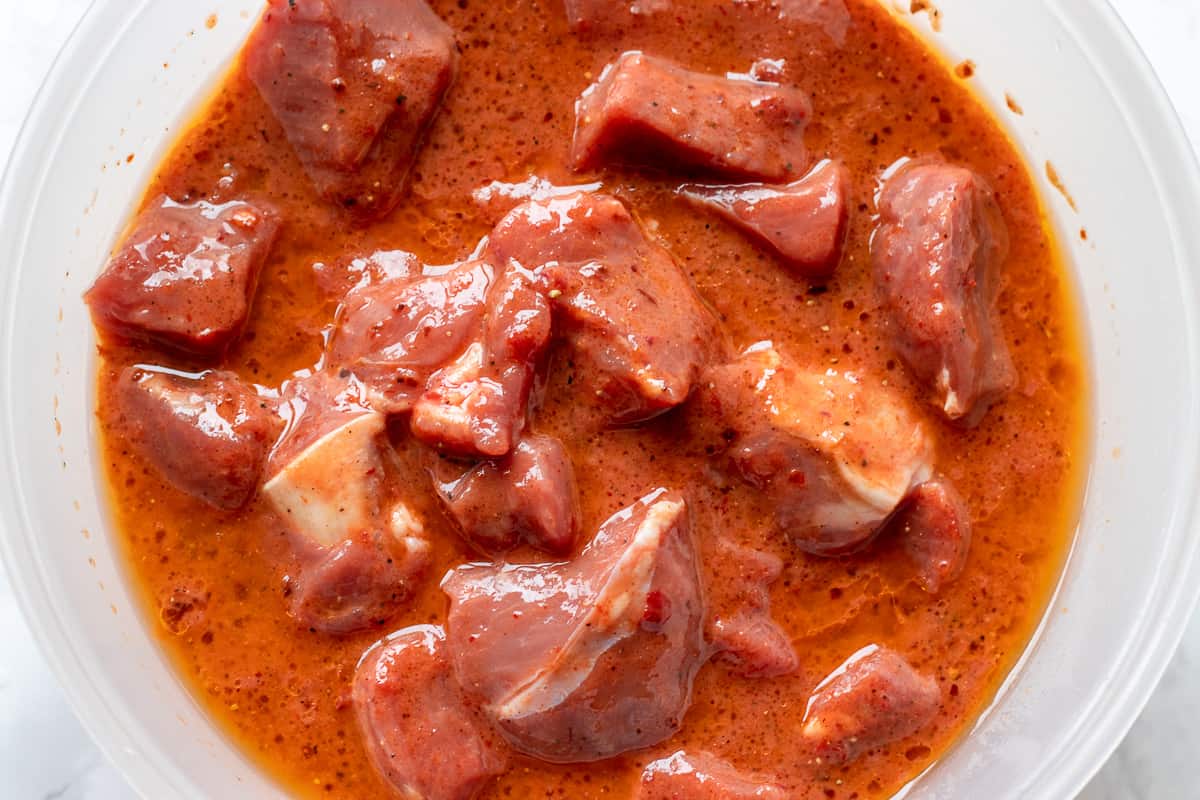 Lamb pieces are in the bowl with marinade