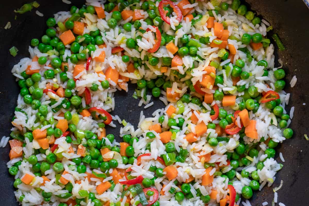 half of the rice is added to the vegetables