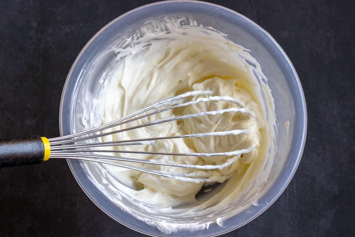 whisking the cream cheese until soft