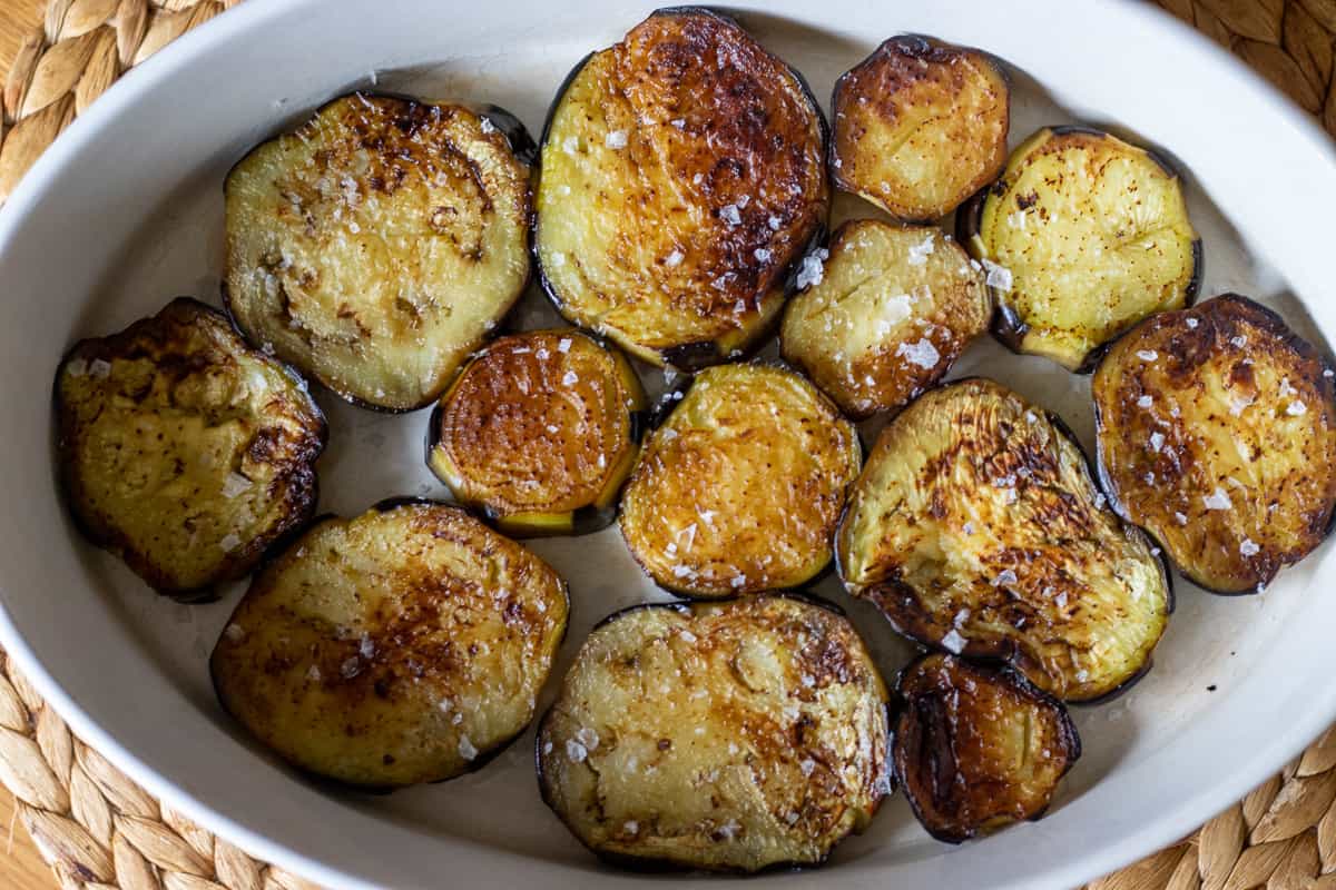fried aubergines for moussaka are layered on the bottom of a oven dish