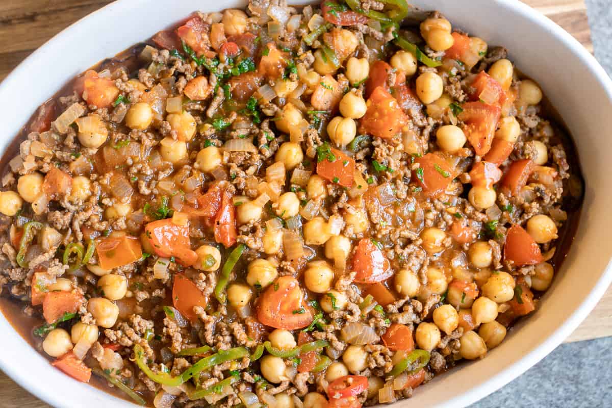 half of the meat sauce is spread on top of the aubergines