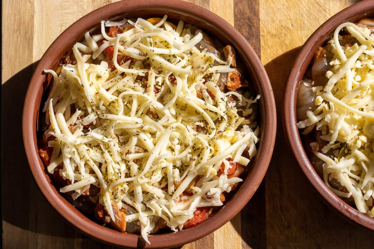 grated cheese and thyme is sprinkled on the prawns