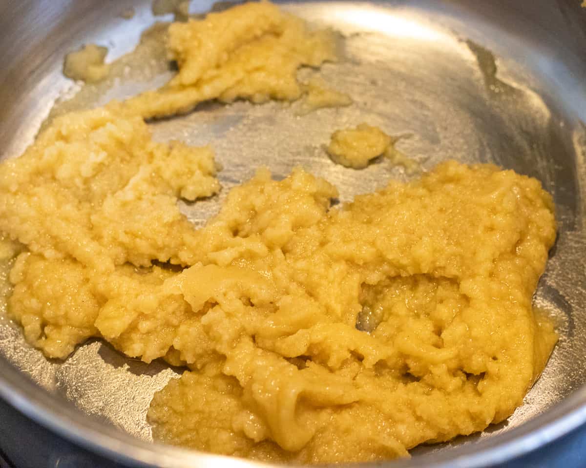 flour and melted butter are mixes in a pan to make béchamel sauce