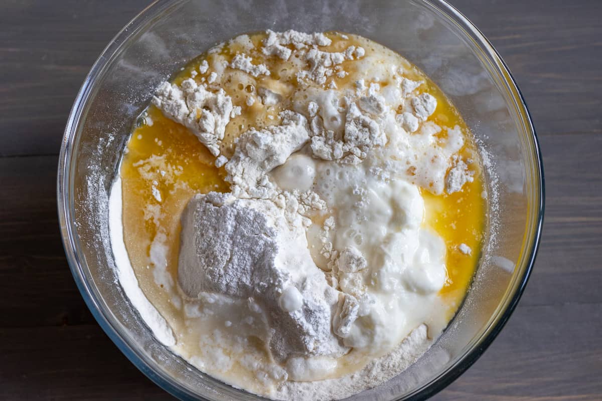 flour, butter, yoghurt, milk and baking powder are placed in a bowl