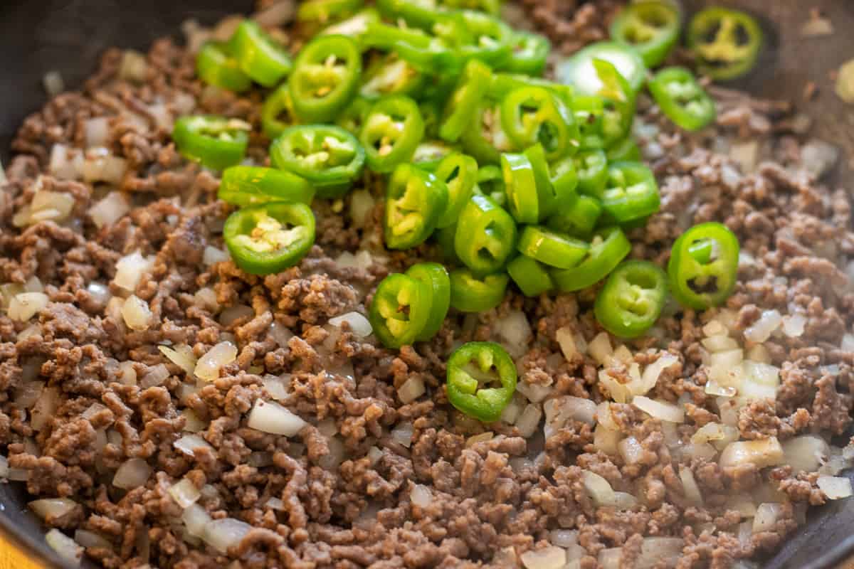 peppers are added to the pan for sautéing