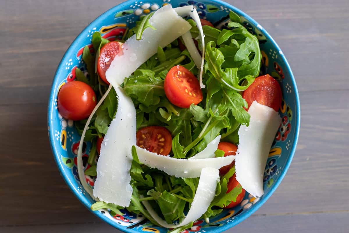 parmesan shavings are added to the bowl