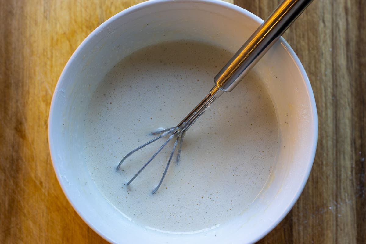 add half of the hot milk to egg/flour mixture