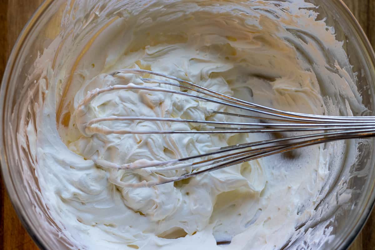 whisking the cream until it stiffs