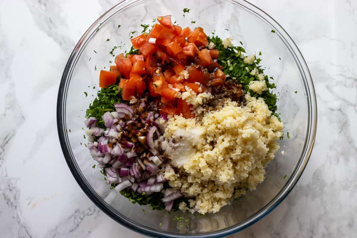 tabbouleh ingredients are placed in a bowl