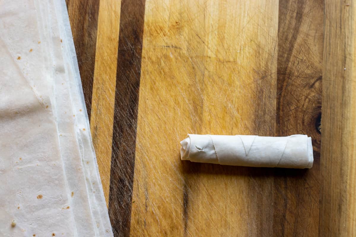 a piece of yufka triangle rolled into a cigarette borek