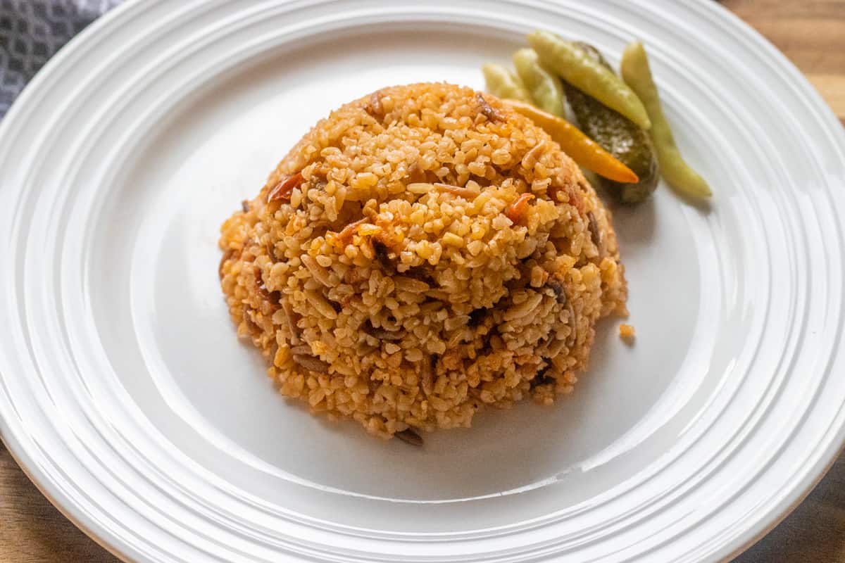 bulgur pilaf served with pickled vegetables 