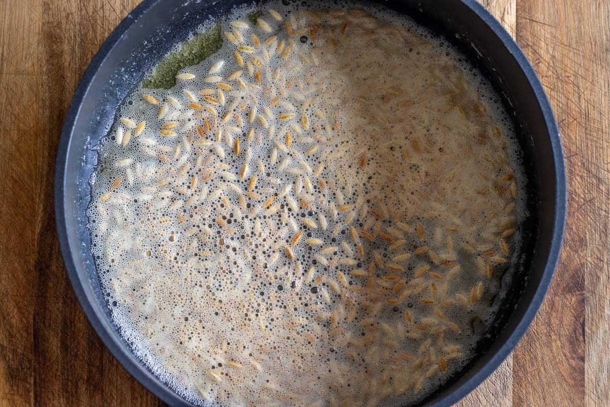 Sautéing the orzo or vermicelli in butter.