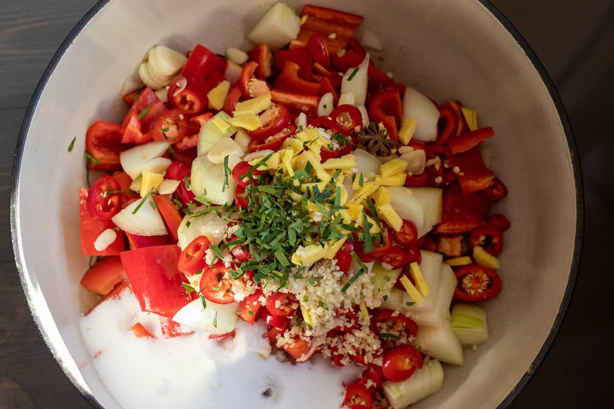 garlic, ginger, chilies, sugar, fish sauce, lime leaves and lemon grass are added to the pan